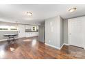 Open-concept living and kitchen area featuring hardwood floors and a bright, airy space at 307 Elm St, Belmont, NC 28012