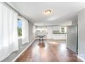 Bright living room with hardwood floors and neutral paint, complemented by white curtains at 307 Elm St, Belmont, NC 28012