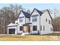 Charming white two-story home with a dark roof, contrasted by black trim, and a well-manicured lawn at 3119 Shenandoah Ave, Charlotte, NC 28205