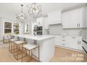Contemporary kitchen with a large island, modern pendant lighting, white cabinetry, and stainless steel appliances at 3119 Shenandoah Ave, Charlotte, NC 28205