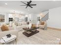Bright, open-concept living room featuring hardwood floors, modern lighting, and stylish neutral-toned furniture at 3119 Shenandoah Ave, Charlotte, NC 28205