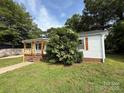 Charming single-story home featuring a cozy front porch, brick foundation and freshly landscaped yard at 322 Buffalo St, Shelby, NC 28150