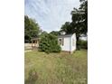 An inviting single-story home highlighted by a well-manicured lawn and traditional wood siding at 322 Buffalo St, Shelby, NC 28150