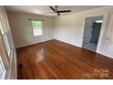 Bright living room with hardwood floors, ceiling fan, and ample natural light through windows at 322 Buffalo St, Shelby, NC 28150