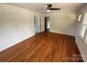 Bright living room with hardwood floors, ceiling fan, and ample natural light through windows at 322 Buffalo St, Shelby, NC 28150