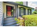 Inviting front entrance with a stone accent wall and covered porch at 3221 5Th Street Nw Ct, Hickory, NC 28601