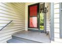 Covered front porch with a red screen door and coat rack at 3221 5Th Street Nw Ct, Hickory, NC 28601