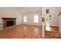 Bright living room features a stone fireplace and wood floors at 3221 5Th Street Nw Ct, Hickory, NC 28601