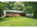 Charming brick ranch-style home with a well-manicured lawn and lush landscaping at 3230 Kingsfield Rd, Rock Hill, SC 29732