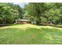 Beautifully maintained lawn with mature trees accenting a classic brick ranch-style home with a private driveway at 3230 Kingsfield Rd, Rock Hill, SC 29732