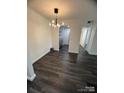 Open dining area featuring modern light fixture, sleek floors, and access to kitchen at 338 Orchard Trace Ln # 8, Charlotte, NC 28213