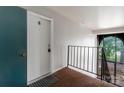 Hallway view featuring a white door with number 8 and black metal railing at 338 Orchard Trace Ln # 8, Charlotte, NC 28213