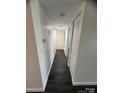 Clean hallway with sleek floors and a linen closet at 338 Orchard Trace Ln # 8, Charlotte, NC 28213