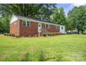 Lovely single story brick home on a lush green lot with mature trees at 346 Fieldstone Cir, Statesville, NC 28677