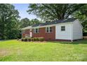 Beautiful exterior of a brick house with green grass and mature trees at 346 Fieldstone Cir, Statesville, NC 28677