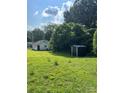 Spacious backyard featuring lush green grass and a handy storage shed at 512 S Gray St, Gastonia, NC 28052