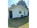 View of the home's rear exterior showcasing a door and barbecue grill at 512 S Gray St, Gastonia, NC 28052