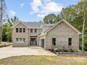 Stunning two-story brick home with a manicured lawn and an attached two-car garage at 5217 Waterfall Ct, Gastonia, NC 28056