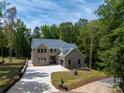 Stunning two-story brick home with a well-manicured lawn and a long driveway leading to an attached garage at 5217 Waterfall Ct, Gastonia, NC 28056