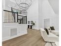 Grand foyer with soaring ceilings, decorative wall paneling, and a striking chandelier at 5217 Waterfall Ct, Gastonia, NC 28056