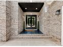 Elegant entryway showcasing a double door with a covered porch and stylish brick accents at 5217 Waterfall Ct, Gastonia, NC 28056