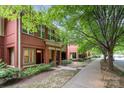 Red brick townhomes with tree-lined street and sidewalk at 530 E 9Th St, Charlotte, NC 28202