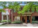 Charming red brick townhomes with inviting front porches and lush, mature landscaping at 530 E 9Th St, Charlotte, NC 28202
