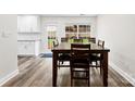 Bright dining room with wooden table and chairs, adjacent to a well-lit backyard at 7144 Marlin St, Gastonia, NC 28056