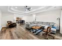 A spacious living room boasting a tray ceiling, hardwood floors, and comfortable seating at 7144 Marlin St, Gastonia, NC 28056