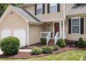 A charming home featuring a well-manicured lawn, complemented by an attached two-car garage and cozy front porch at 7212 Morsey Ct, Charlotte, NC 28269