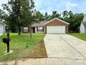 Charming brick and vinyl home featuring an expansive driveway and two car garage at 7267 Sandown Ct, Harrisburg, NC 28075