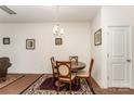 Bright dining room includes a wood table, four chairs, and decorative wall art at 8953 Bradstreet Commons Way, Charlotte, NC 28215