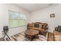Comfortable living room features seating, a coffee table, and a view of the outdoors at 8953 Bradstreet Commons Way, Charlotte, NC 28215