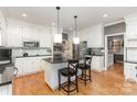 Spacious kitchen with white cabinets, granite countertops, stainless steel appliances, and a central island at 905 Mangionne Dr, Matthews, NC 28105