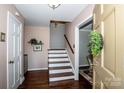 Traditional entryway features hardwood floors, staircase to upper level and entry to living spaces at 928 Tally Ho Ct, Charlotte, NC 28212