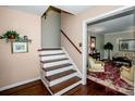 Classic stairway with wooden steps, white risers, and access to the home's living room at 928 Tally Ho Ct, Charlotte, NC 28212