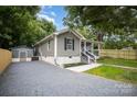 View of home exterior, driveway and storage shed at 952 Salisbury St, Wadesboro, NC 28170