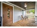 Relaxing front porch with wood floors and a comfortable seating area at 952 Salisbury St, Wadesboro, NC 28170