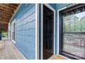 A welcoming blue exterior shows the entry door to the condo unit at 1038 Southwest Dr, Davidson, NC 28036