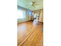 Living room with hardwood floors and views into the kitchen and front door at 1073 Springdale Dr, Maiden, NC 28650