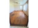Living room with hardwood floors, vintage wallpaper, and natural light from a large window at 1073 Springdale Dr, Maiden, NC 28650