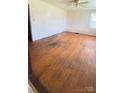 Living room with hardwood floors, vintage wallpaper, and natural light from a large window at 1073 Springdale Dr, Maiden, NC 28650