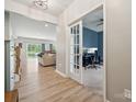 Inviting foyer featuring hardwood floors leading into a large living area and office with glass french doors at 1311 Rowan Ln, Monroe, NC 28110