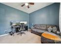 Stylish home office with modern desk setup, blue walls, comfortable seating, and ample space at 1311 Rowan Ln, Monroe, NC 28110