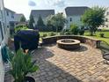 Charming backyard featuring a custom stone fire pit and a paved patio area, perfect for outdoor entertaining at 1349 Bridgeford Nw Dr, Huntersville, NC 28078