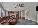 Inviting living room with hardwood floors, a ceiling fan, and an open layout that flows into the kitchen at 1349 Bridgeford Nw Dr, Huntersville, NC 28078