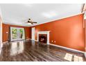 Inviting living room featuring hardwood floors, a fireplace with hearth, and access to an outdoor deck at 14402 Raynham Dr, Charlotte, NC 28262