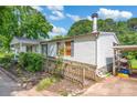 This home offers a ramp, well-kept landscaping, and a convenient covered parking area at 1532 Buffalo Shoals Rd, Claremont, NC 28610