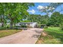 Features this house includes covered parking, a wide driveway, beautiful trees, and a well-maintained lawn at 1532 Buffalo Shoals Rd, Claremont, NC 28610