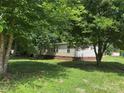 Back view of charming single story home with brick foundation and level lawn at 1555 Moore Rd, York, SC 29745